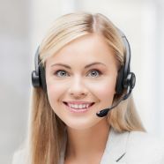 A smiling customer service representative wearing a headset, with a friendly and professional demeanor, ready to assist.